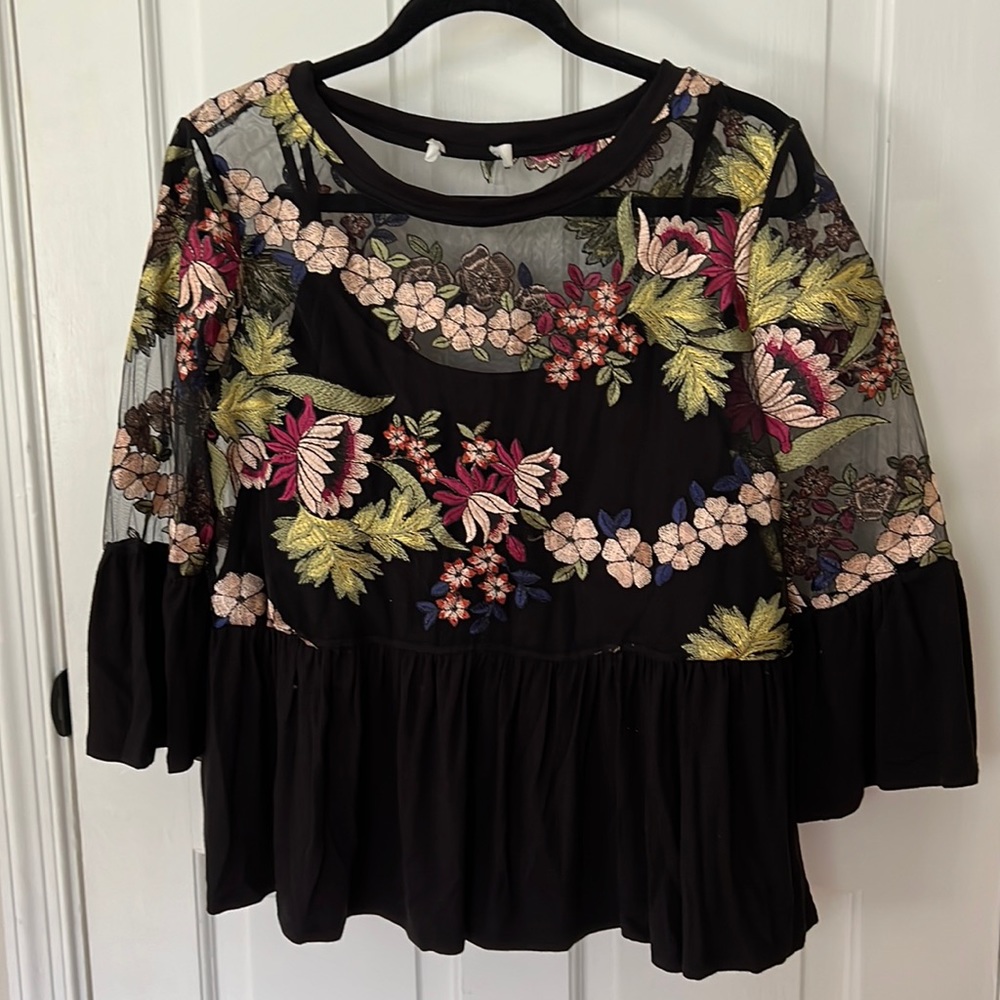 Black peplum top with floral stitching